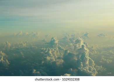view of the cloud space from the window of the aircraft flying high in the sky, above the clouds