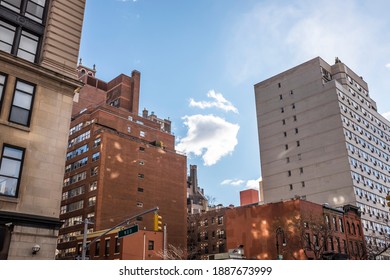 A view of clouds in between buildings
