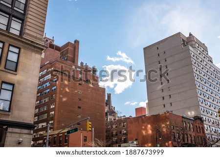 A view of clouds in between buildings