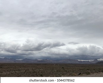 View of clouds over mountain range in Mojave Desert.