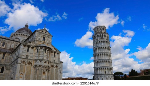 View of Cloudy blue sky in Pisa Cathedral (Duomo di Pisa) with Leaning Tower  (Torre di Pisa) Tuscany, Italy.The Leaning Tower of Pisa is one of the main landmark in Italy.