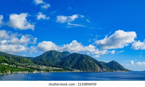 A view of the coast of Dominica and the jungle under a blue sky with beautiful clouds - Shutterstock ID 2133896959
