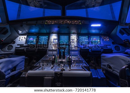 A view of the cockpit of a large commercial airplane, a cockpit trainer. Cockpit view of a commercial jaircraft cruising