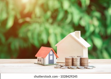 View Of coin stack with house model on green background, savings plans for housing, financial concept,Mortgage loading real estate property with loan money bank concept.Property Tax Concept - Shutterstock ID 1028429245