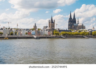 view of Cologne Cathedral and the Hohenzollern Bridge. The Gothic architecture of the cathedral contrasts beautifully with the iconic steel structure of the bridge. - Powered by Shutterstock