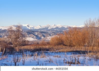 View of the Colorado Indian Peaks area of the Rocky Mountain Continental Divide from the prairie east of Boulder, in early morning bright sunlight in winter