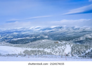 View Of Colorado Mountain Range After Snowfall;  Chairlift And Service Building At Distance