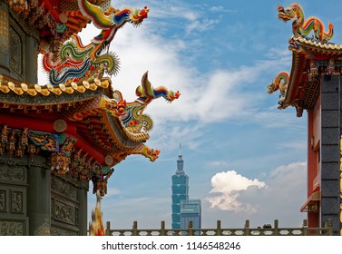 View of the colorful eaves of a Taiwanese temple decorated with delicate & fancy sculptures (dragon & phoenix) in traditional mosaic art and the landmark 101 Tower in background in Taipei City, Taiwan