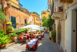 View Of Colorful Narrow Pedestrian Street With Cafe In Old Town Taormina. Sicily, Italy