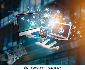View of a Computer and devices displayed on a futuristic interface with business network - Multimedia and technology concept