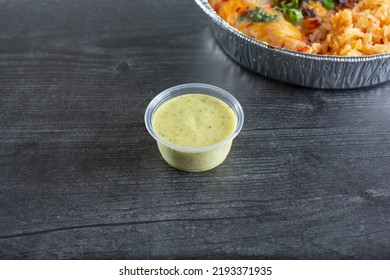 A View Of A Condiment Cup Of Avocado Salsa.