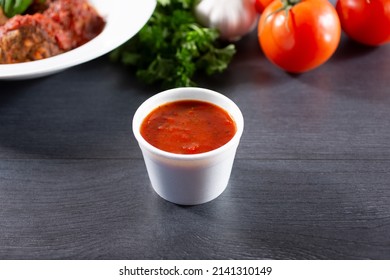 A View Of A Condiment Cup Of Marinara Sauce.