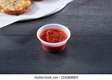 A View Of A Condiment Cup Of Marinara Sauce.