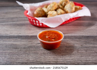 A View Of A Condiment Cup Of Marinara Sauce.