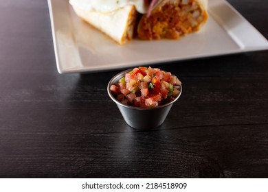 A View Of A Condiment Cup Of Pico De Gallo Salsa.