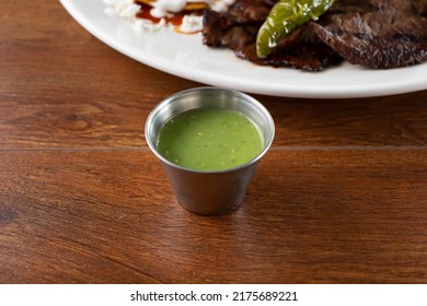 A View Of A Condiment Cup Of Salsa Verde.