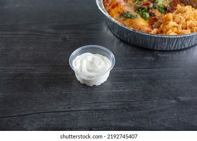 A View Of A Condiment Cup Of Sour Cream.