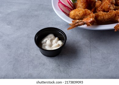 A View Of A Condiment Cup Of Tartar Sauce.