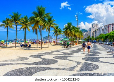 View of Copacabana beach and Leme beach with palms and mosaic of sidewalk in Rio de Janeiro, Brazil. Copacabana beach is the most famous beach of Rio de Janeiro, Brazil. cityscape of Rio de Janeiro
