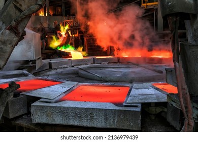 View of the copper casting to the molds in the smelting of the industrial plant. Smelting is a process of applying heat to ore in order to extract a base metal. Anode casting machine (Casting wheel).