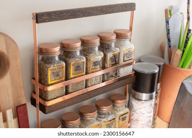 A view of a counter spice rack, seen in a home kitchen setting. - Shutterstock ID 2300156647