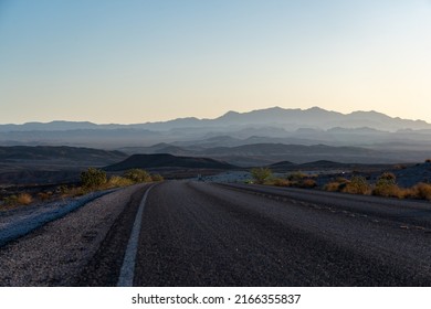 View of Country Road With Right Curve Ahead and Mountains in the Background - Powered by Shutterstock