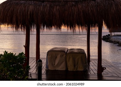 view of covered table under a straw hut with ocean view