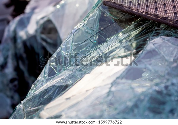 A view of a crumbled, shattered windshield on a\
damaged vehicle.