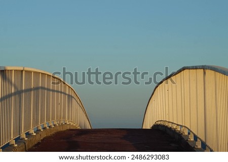 View of curved bridge with railing