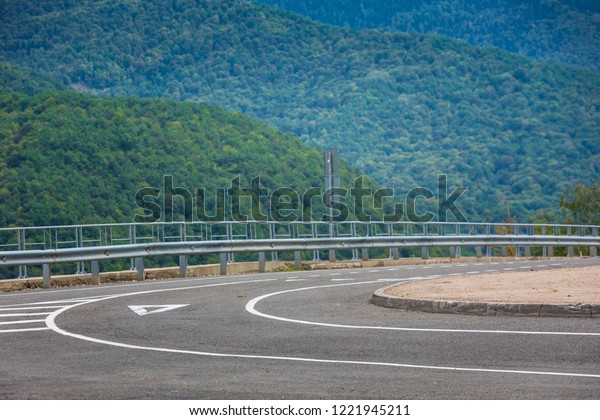 A view of a curved
road. Driving a car on mountain road. Asphalt road in mountain.
Empty road background