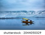 A view of Dal Lake in winter, and the beautiful mountain range in the background in the city of Srinagar, Kashmir, India.