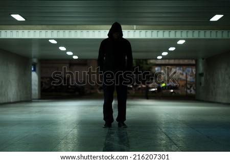 View of dangerous man walking at night