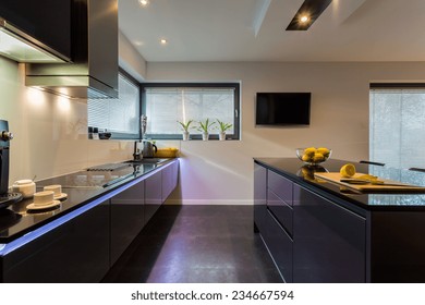 View Of Dark Furniture In White Painted Kitchen