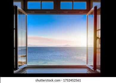 view from a dark room at sea during sunset through an open window