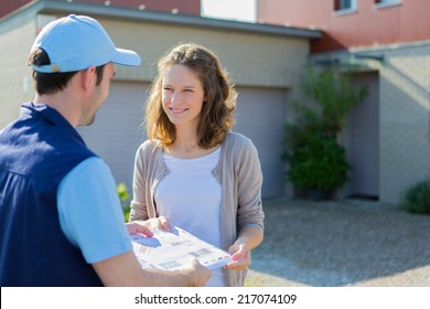 View Of A Delivery Man Handing Over A Registered Mail