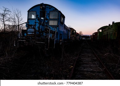 A View Of Derelict Conrail Locomotives At Sunset At An Abandoned Train Railroad Yard In Ohio.