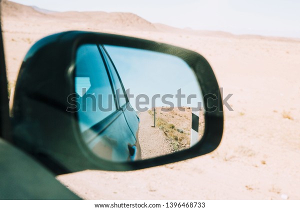 View of desert in car\
mirror