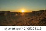 View of the desert and dunes during the golden hour. The rays of the setting sun in the desert. Sunset with highlights.