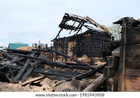 View of a deserted run down wooden village house after a fire