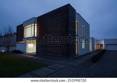 Similar – dark house at night with illuminated windows