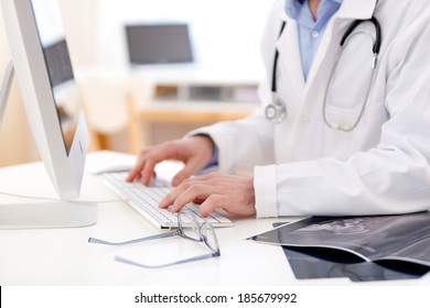 View of Details of doctor hands typing on keyboard