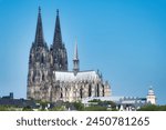 view from deutz over the rhine to the imposing gothic cologne cathedral in the old town on a sunny day