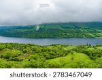 View from the Devils Chimney Waterfall area toward Glencar Lough in northwest Ireland. Misty green valley, lake and cliffs in the Sligo Leitrim border landscape, Ireland