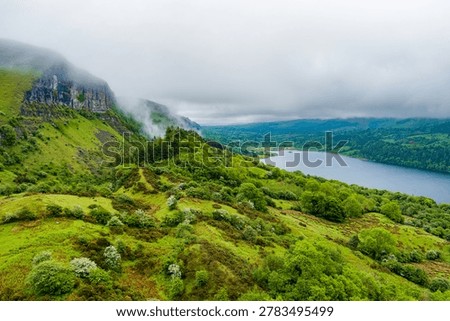 View from the Devils Chimney Waterfall area toward Glencar Lough in northwest Ireland. Misty green valley, lake and cliffs in the Sligo Leitrim border landscape, Ireland