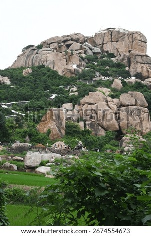 View of devotees lining up to visit Hanuman Temple on Anjanadri Hill at Hampi, Karnataka, India