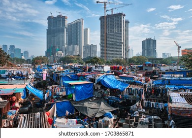 View of Dhobi Ghat (Mahalaxmi Dhobi Ghat) is world largest open air laundromat (lavoir) in Mumbai, India with laundry drying on ropes. Now one of signature landmarks and tourist attractions of Mumbai - Shutterstock ID 1703865871