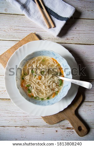 View directly from above of noodles in clear soup with use of selective focus. Popularly known as thukpa, a delicacy from Nepal.