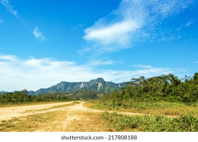 View Of A Dirt Road And Green Jungle Covered Hills In Rurrenabaque, Bolivia