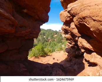 View of a dirt trail winding through towering red rocks at Garden of the Gods in Colorado. - Shutterstock ID 1624675969