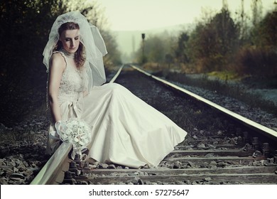 A view of a disappointed bride on a railway